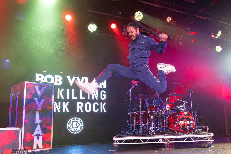 Bob Vylan's Bobby Vylan leaping high in the air on stage